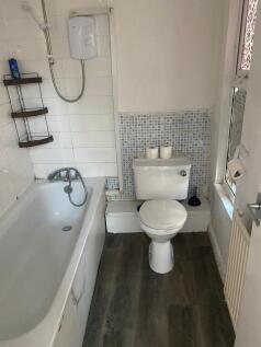 A compact bathroom suite featuring a clean whit...