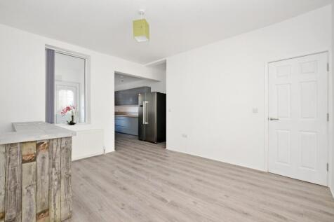 Bright and modern living room featuring light w...