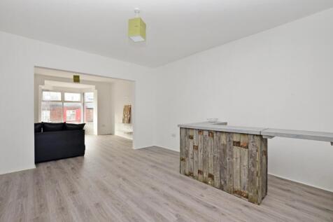 Bright and spacious living room featuring fresh...