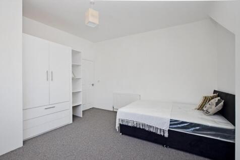 A bright and clean double bedroom featuring a c...
