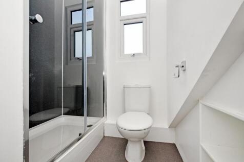Bright, clean bathroom featuring a modern showe...