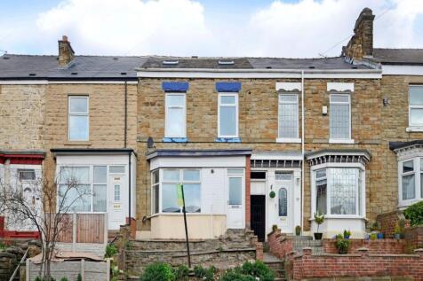 Traditional terraced stone-fronted houses with ...