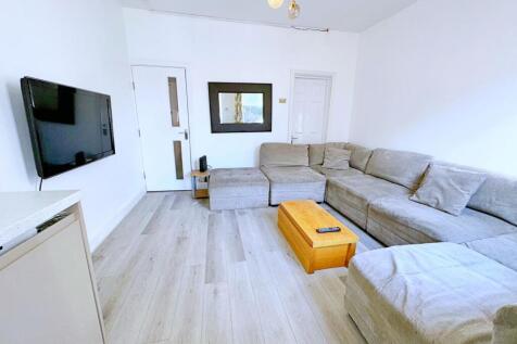 Bright and modern living room featuring a large...