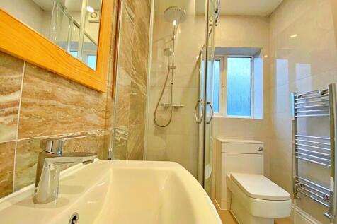 Bright and modern bathroom featuring a spacious...