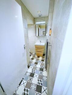 A stylish bathroom featuring a patterned tiled ...