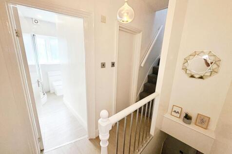 Bright and tidy hallway featuring a modern pend...