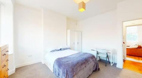 A cozy double bedroom featuring ample natural l...