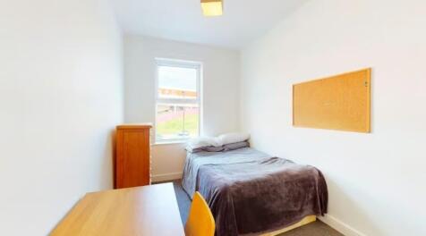 This cozy double bedroom features a comfortable...