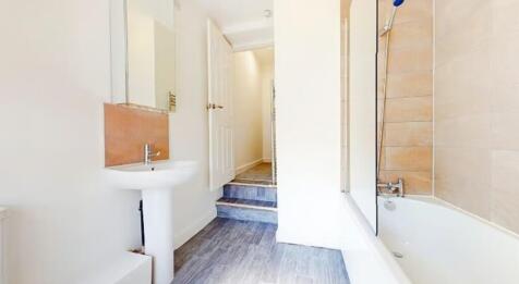 Bright and clean bathroom featuring a spacious ...