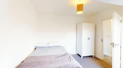 Cozy double bedroom featuring a comfortable bed...