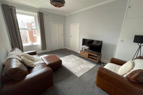 A cozy and well-maintained living room featurin...