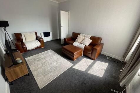 A cozy living room featuring comfortable leathe...