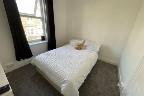 Bright and cozy double bedroom featuring a comf...