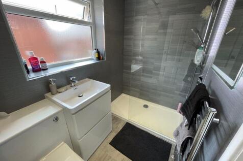 A modern bathroom featuring a walk-in shower wi...