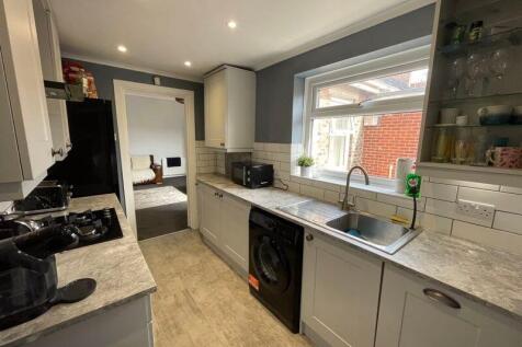 Bright and modern kitchen featuring sleek grey ...