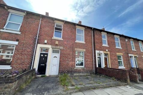 Traditional terraced brick house with a charmin...