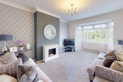 Spacious and stylish living room featuring a co...