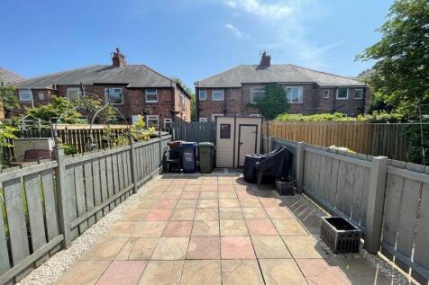 A bright and spacious paved garden area enclose...