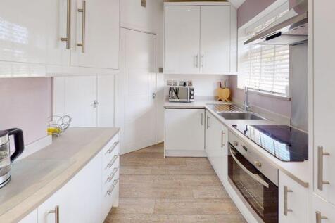 Bright and modern kitchen featuring ample count...