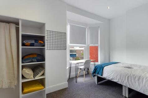 A bright and inviting double bedroom featuring ...