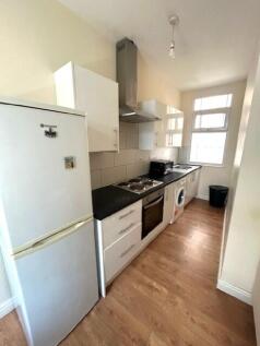 Bright and modern kitchen featuring ample natur...