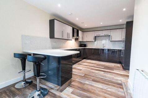 A modern kitchen featuring sleek cabinetry, a b...