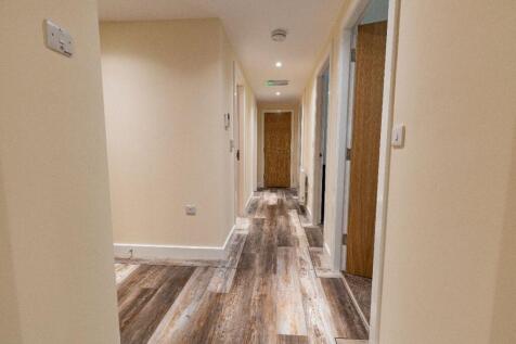 A clean and well-maintained hallway featuring m...