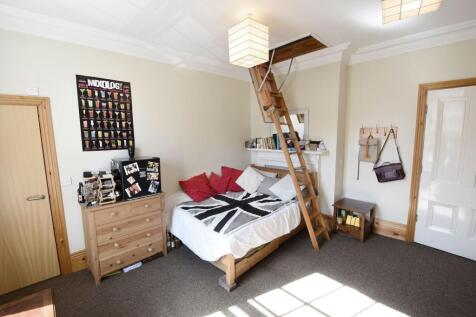 Bright and cozy double bedroom featuring a wood...