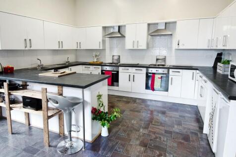 Bright and modern kitchen featuring ample white...