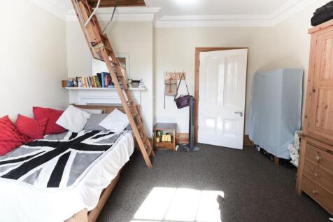Bright and cozy single bedroom featuring a comf...