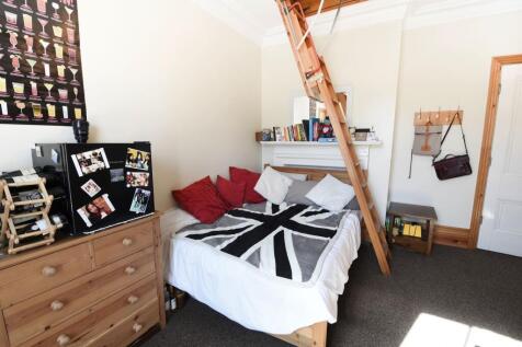 Bright and cozy single bedroom featuring a comf...