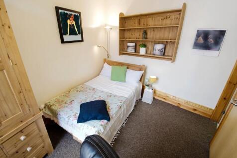 Cozy and neatly arranged bedroom featuring a wo...