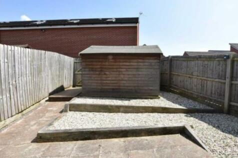 A well-maintained garden area featuring a woode...