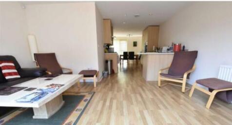 A bright and inviting living room with wooden f...