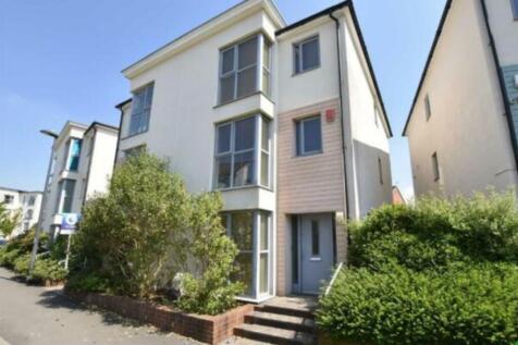 Modern three-storey house with large windows an...