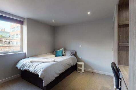 A tidy and well-lit double bedroom featuring a ...