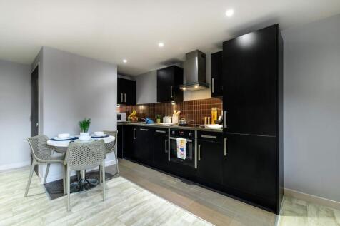 Modern kitchen with sleek black cabinetry and i...