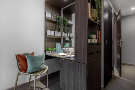 A modern communal workspace featuring a built-i...