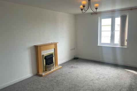 Bright and airy living room featuring a large w...