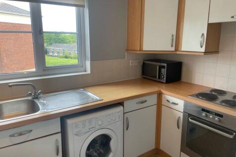 A bright and functional kitchen featuring a lar...