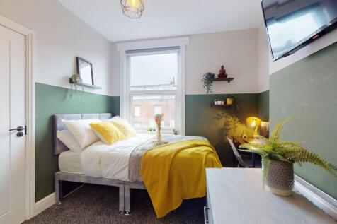 This charming double bedroom features a cozy la...