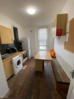 A well-equipped kitchen featuring wooden cabine...