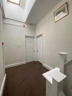 A bright and clean hallway with white walls and...