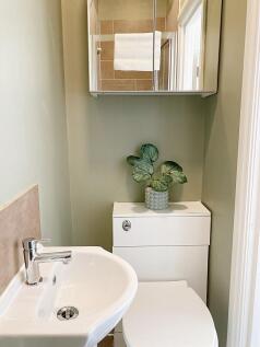 A compact and tidy single toilet room featuring...