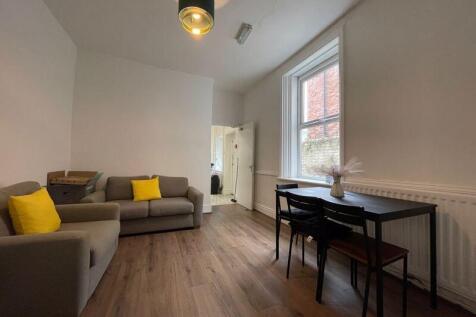 A bright and modern living room featuring comfo...