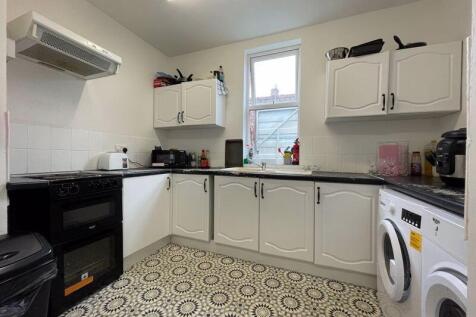 Bright and clean kitchen featuring ample white ...