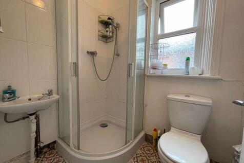 A bright and tidy bathroom suite featuring a co...