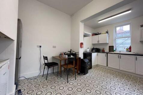 Bright and clean kitchen with ample cupboard sp...