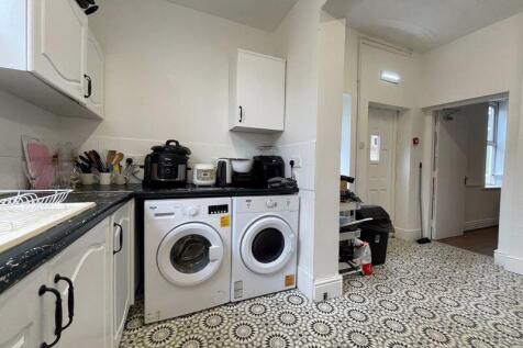 A modern kitchen featuring a washing machine an...
