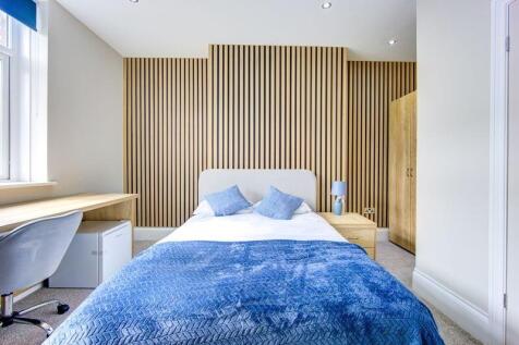Bright and stylish master bedroom featuring a c...